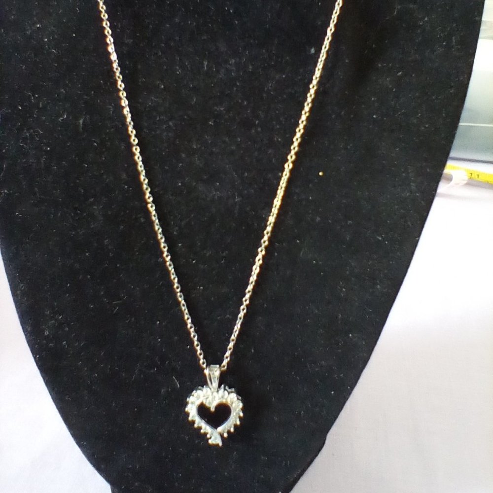 Heart pendant made of diamond like stones on a  silver chain.
